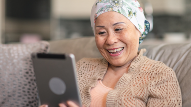 Woman on ipad while sitting on couch 