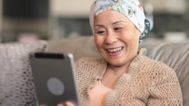 Woman on ipad while sitting on couch 