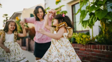 two girls and a woman dancing 