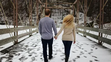woman and man walking while holdings hand 