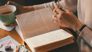 hand flipping the page of a book