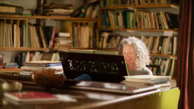 Woman sitting down reading a book with radio