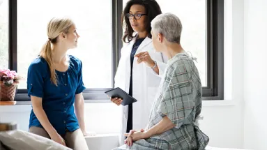 HCP speaking with a patient and family member 