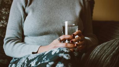 person holding cup of water