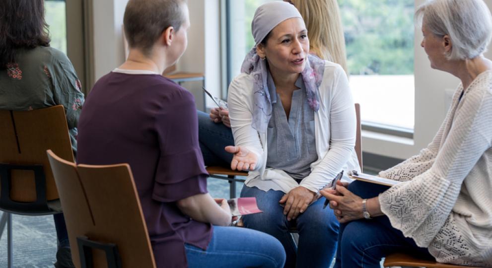 Three women sitting in a circle talking