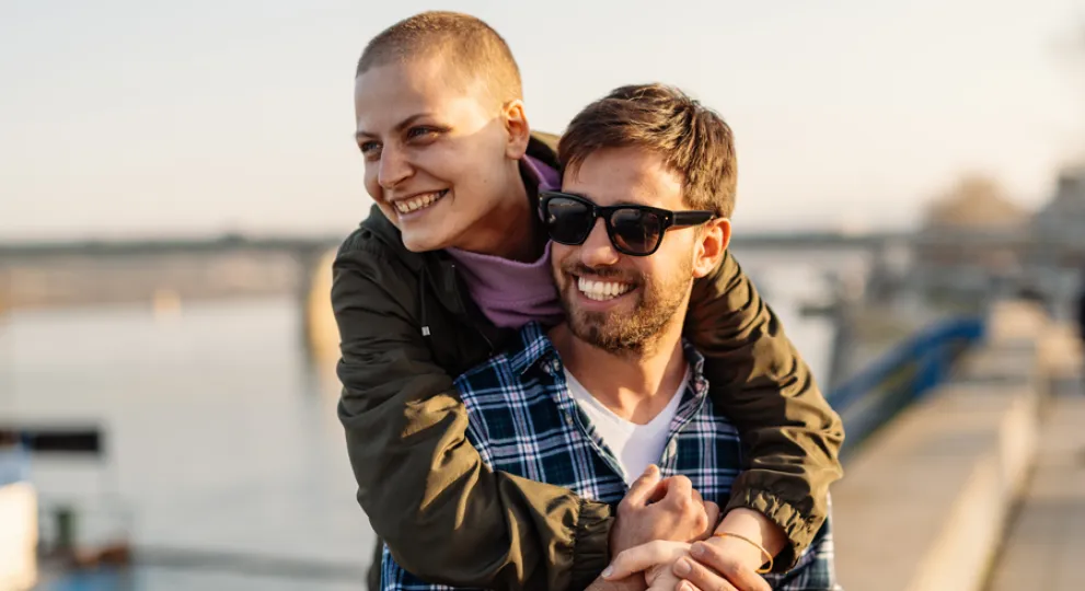 A couple walking by water