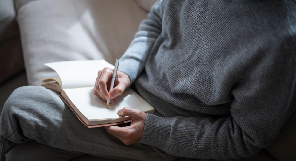 person writing in notebook