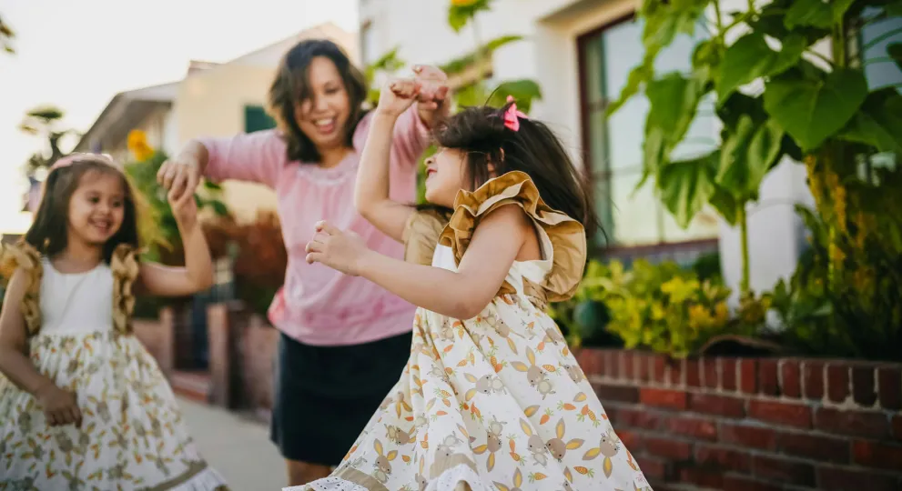 two girls and a woman dancing 