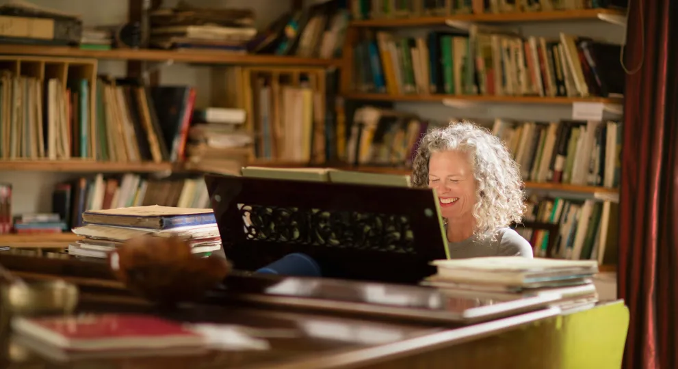 Woman sitting down reading a book with radio