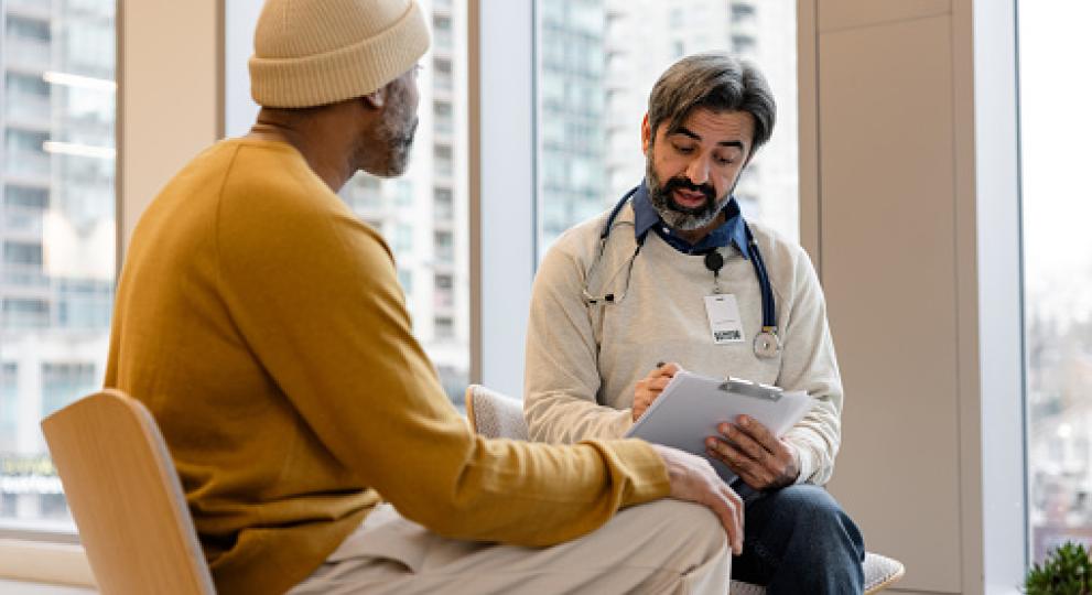A physician and patient sitting and talking