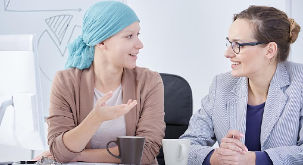 two women talking over coffee