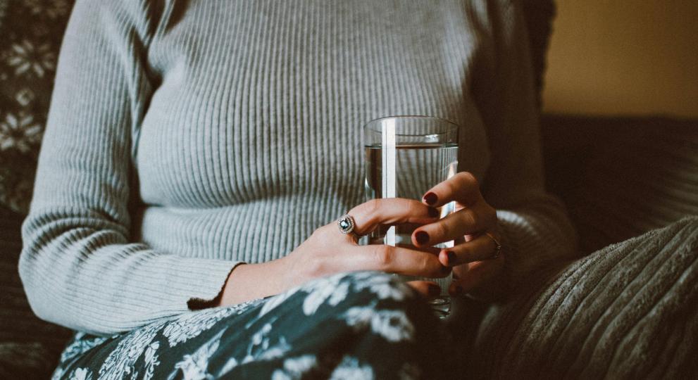 person holding cup of water